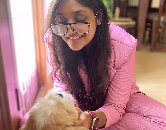 Kashish smiling at dog